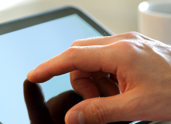 View of a person's hand using their tablet