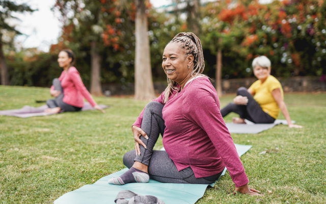 Women doing yoga in grass