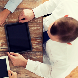 Business man plugging in a tablet
