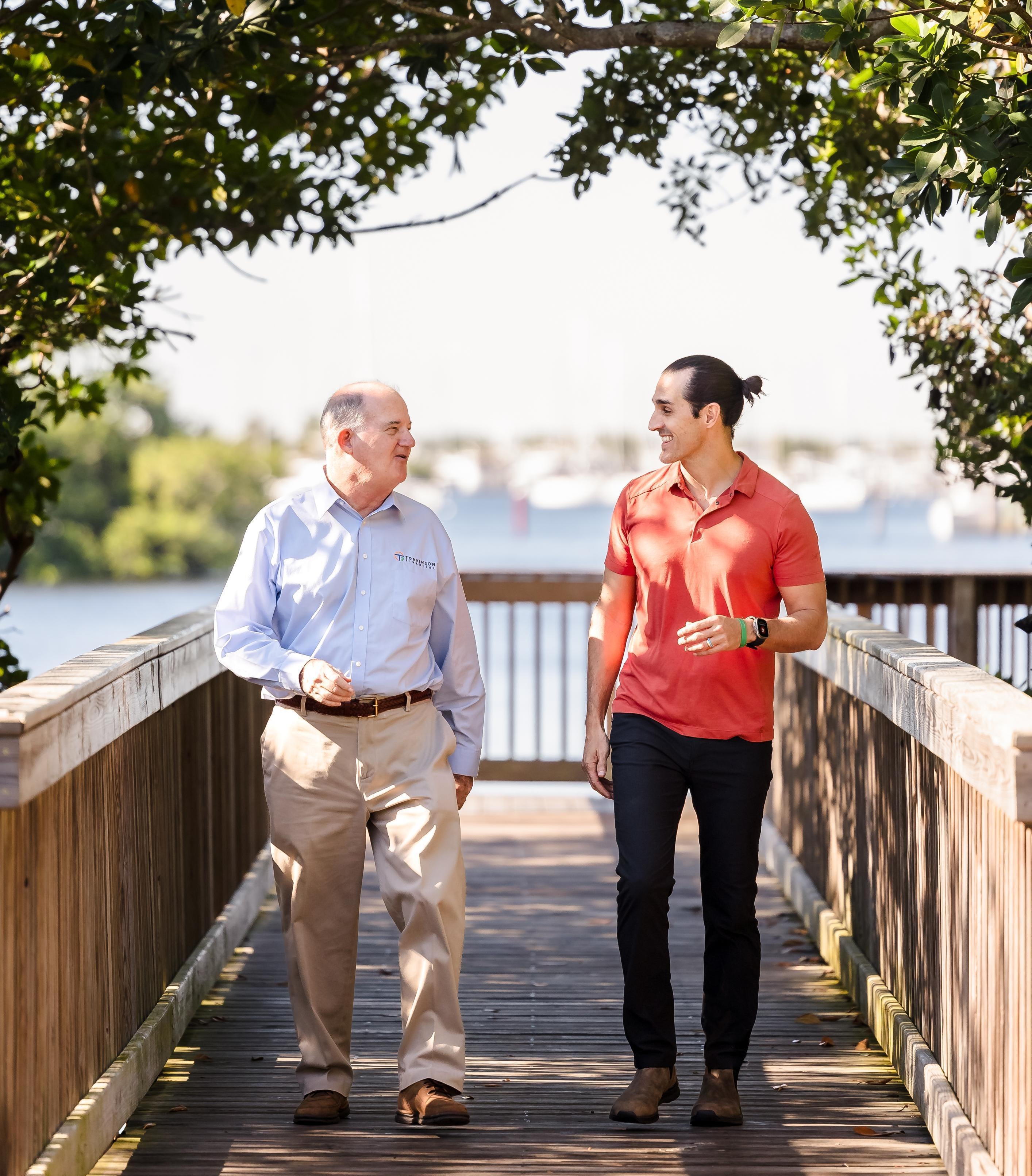 Rick Tonkinson and Steven Tonkinson talking and walking together
