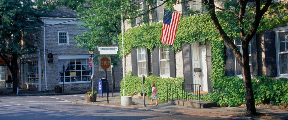 Street and buiding with an American flag above the door