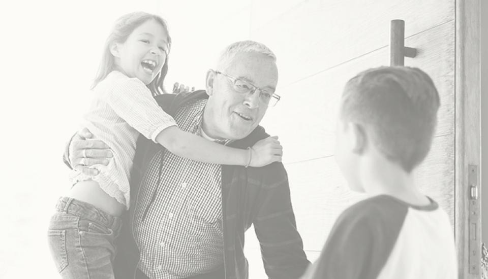 grandfather-holding-one-of-his-grandchildren-greeting-his-other-grandchild