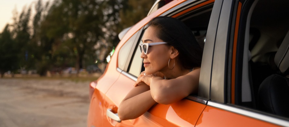 Woman looking out of the window of a car