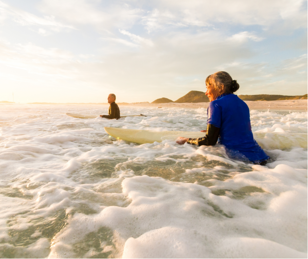 Two surfers in foamy water