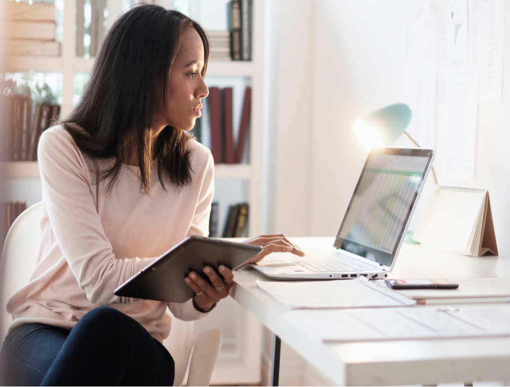 Woman working at laptop in her home office.