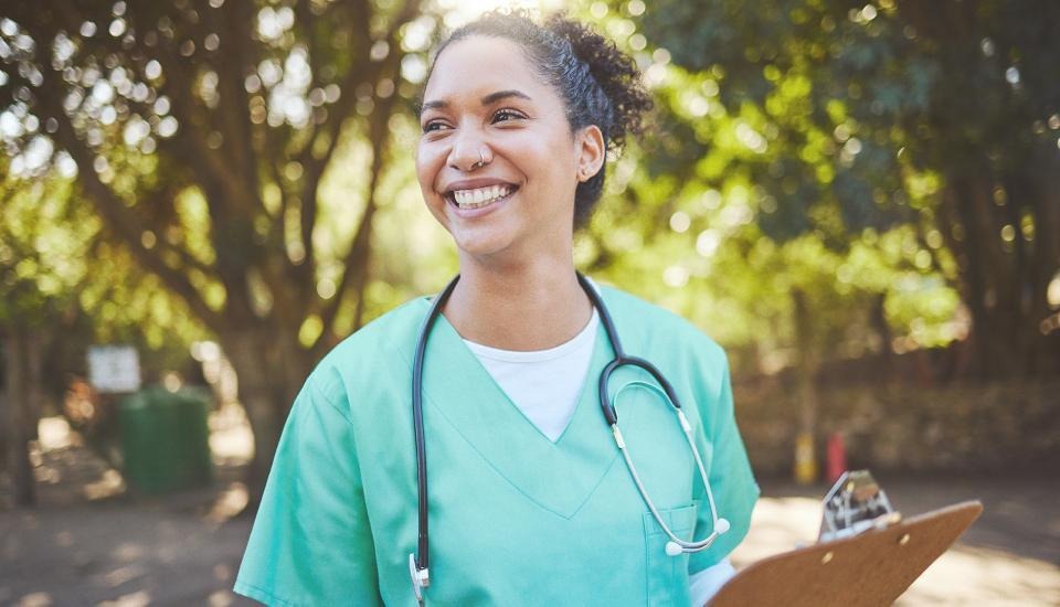 Woman who is a doctor smiling outside