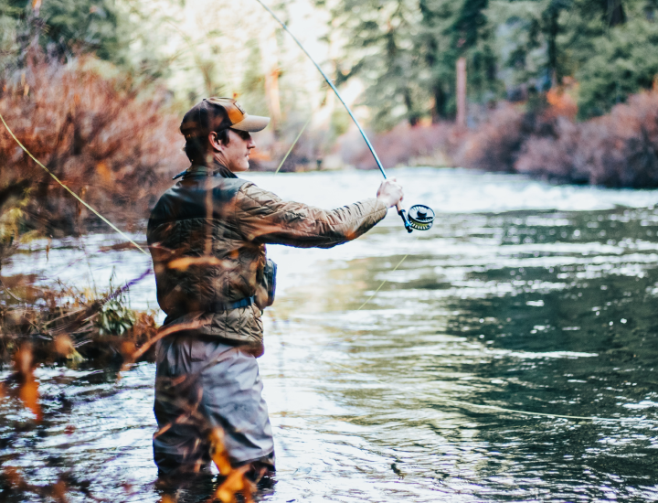 man fly-fishing in a stream