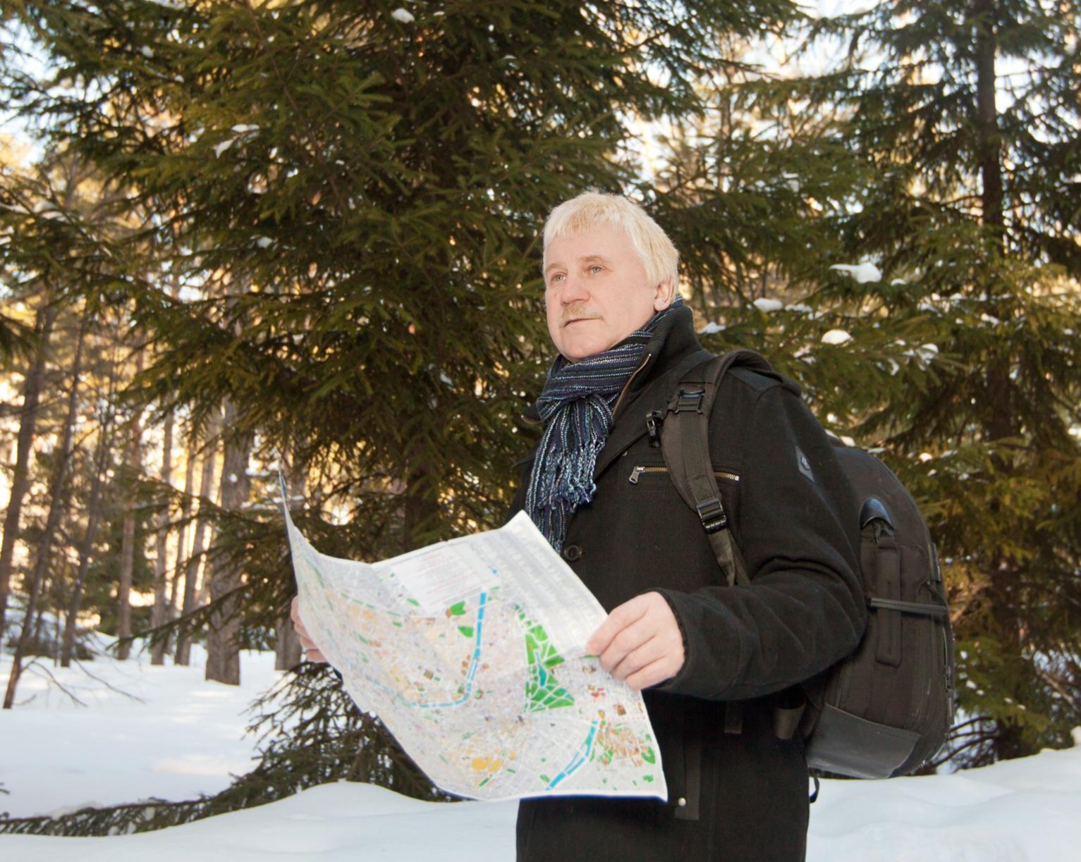 Man hiking and consulting a map