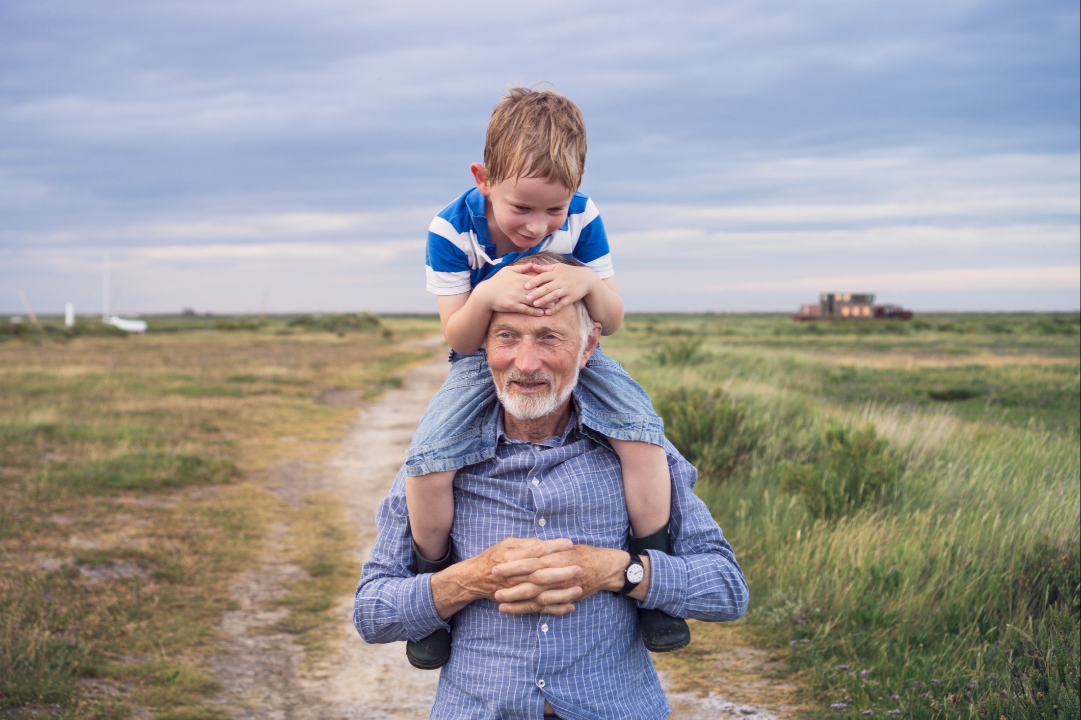 Child on grandfathers shoulders