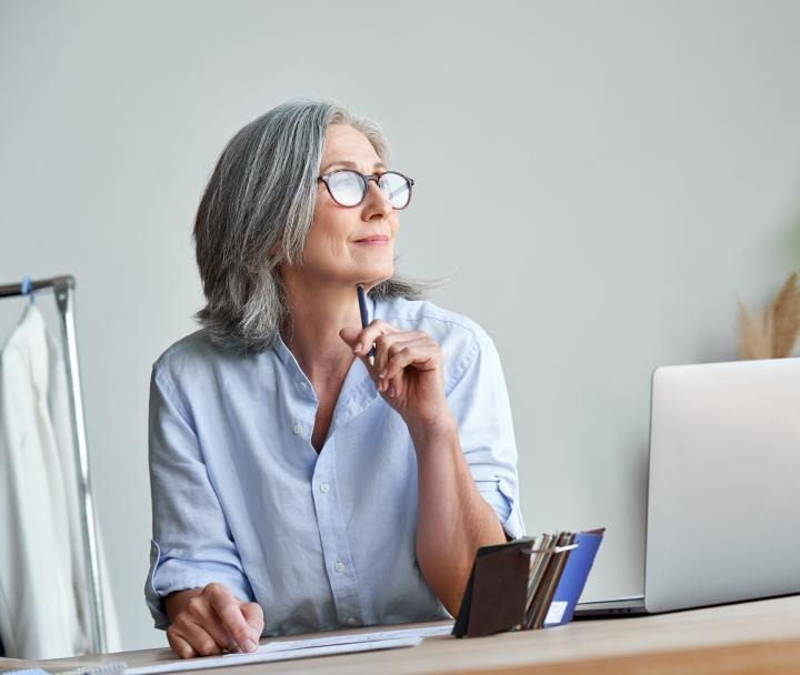 Woman looking confident, sitting at desk.