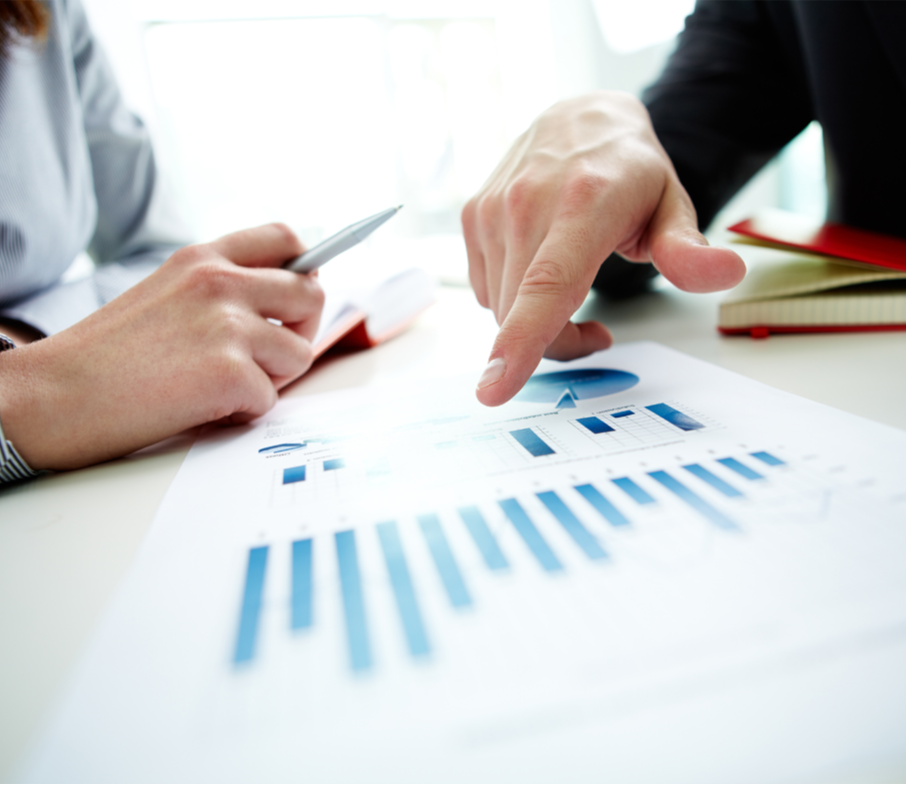 hands pointing at chart on desk