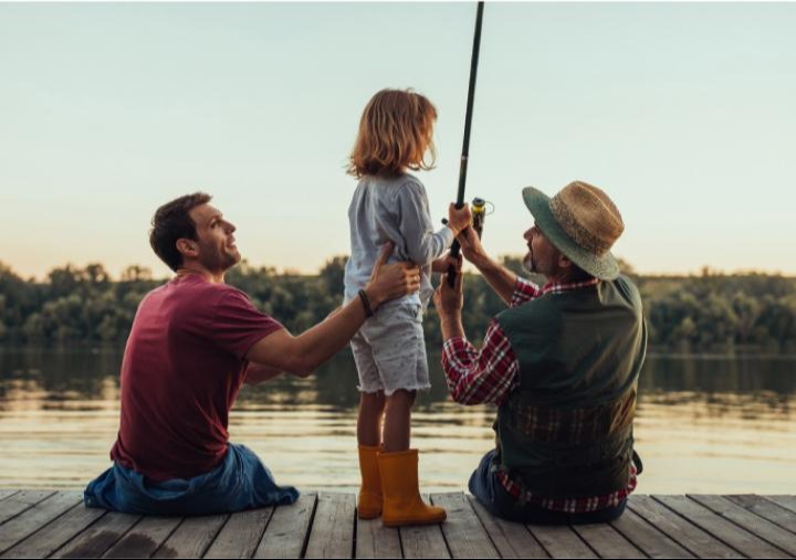 Father-and-son-help-granddaughter-fish