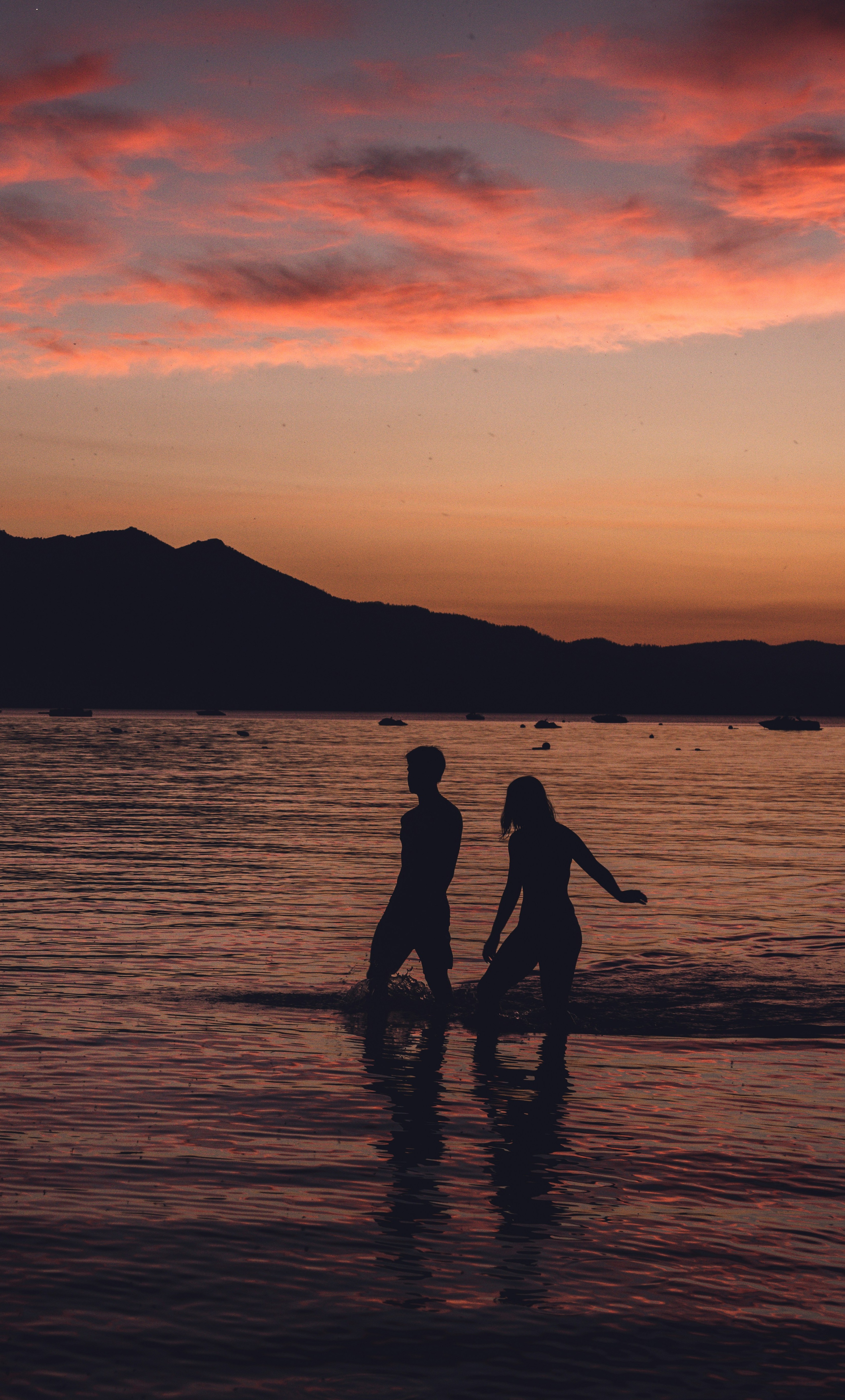 couple swimming at sunset