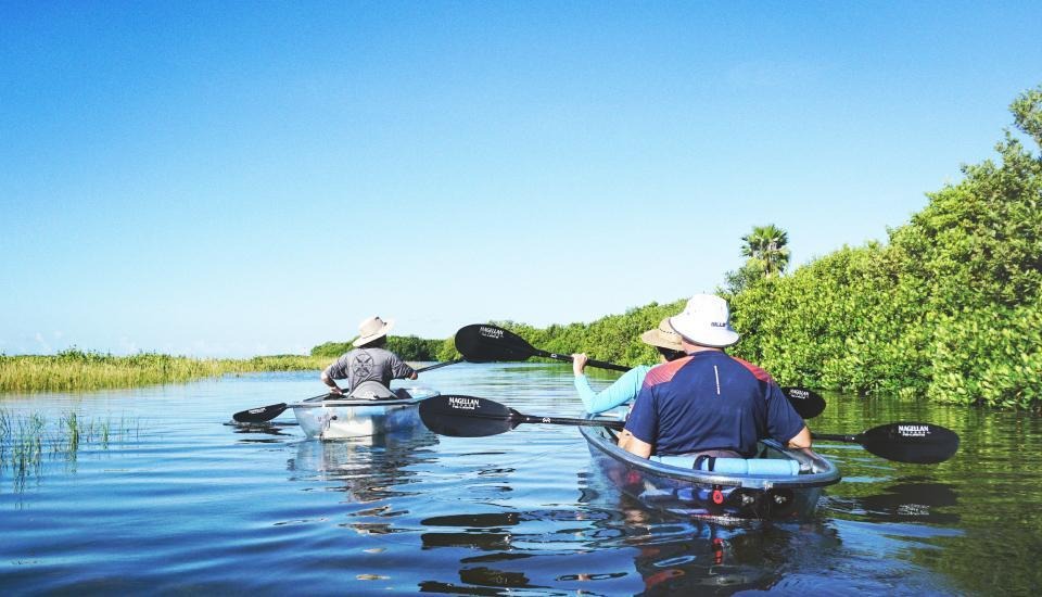 Two kayaks rowing down a river