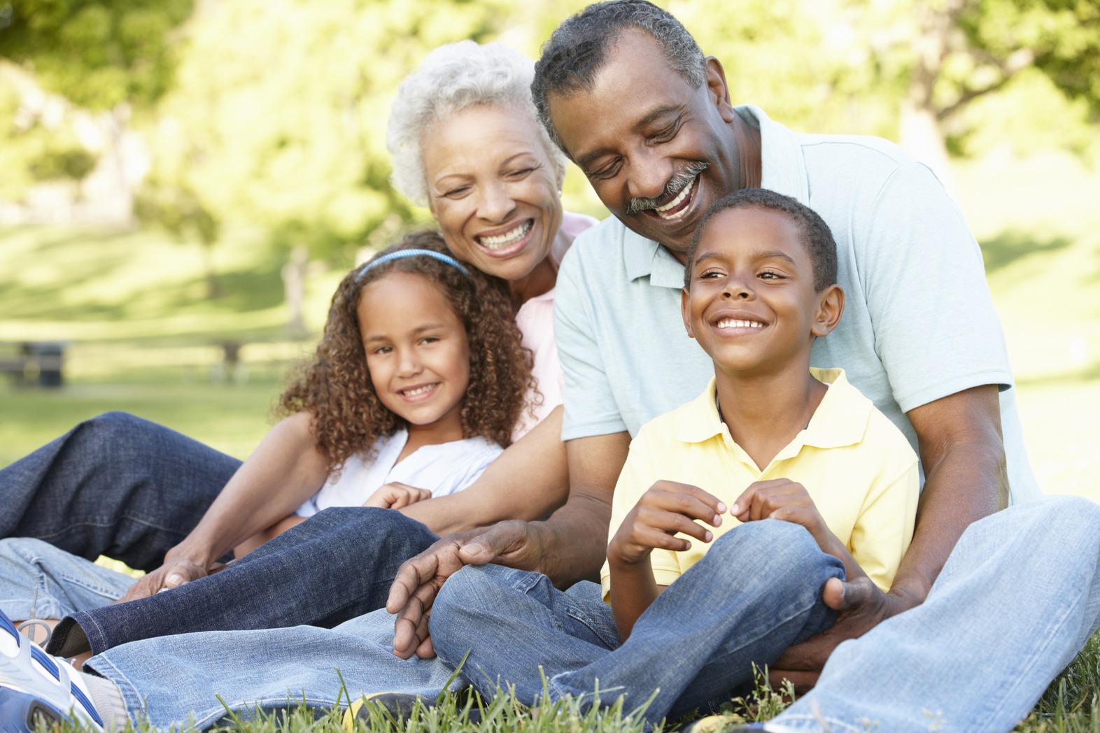 Grandparents playing with their grandchildren in the park