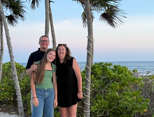 Shelley Bowen with her family near palm trees