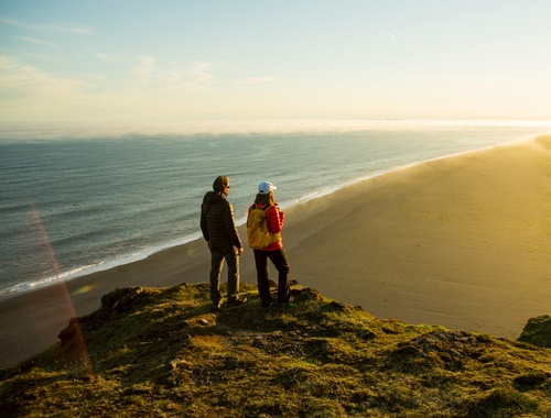 Couple on rock overlooking beach
