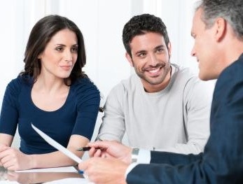 Office - Financial consultant reviews investments with a couple