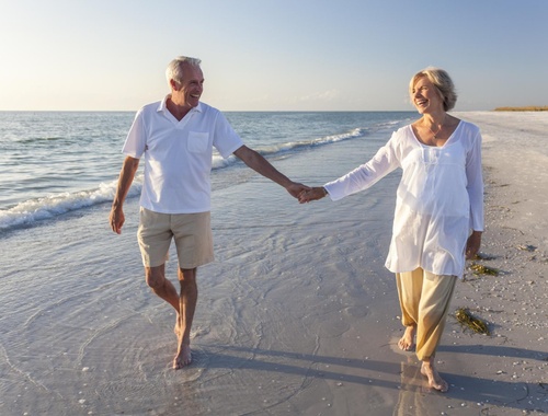 Retired couple on a beach walk