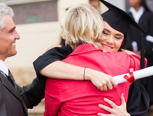 Graduate and mother hugging