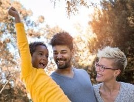 Happy family with child outdoors.