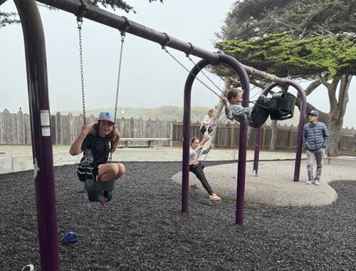 Family fun on Moonstone Beach swings
