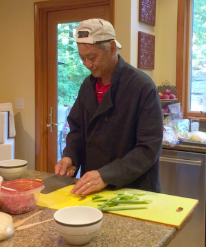Chef Moy demonstrating knife skills during a cooking class