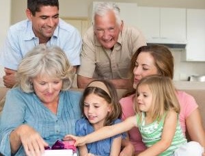 Multigenerational family opening a gift together