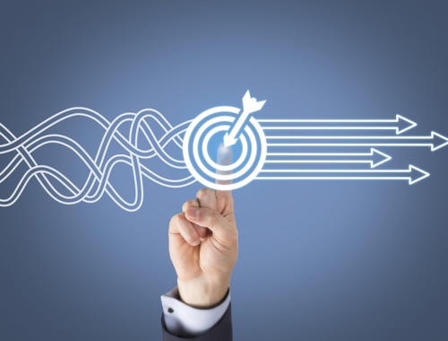 person pointing at a graphic of a bullseye