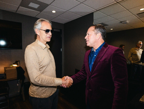Brad shaking Andrea Bocelli's hand.