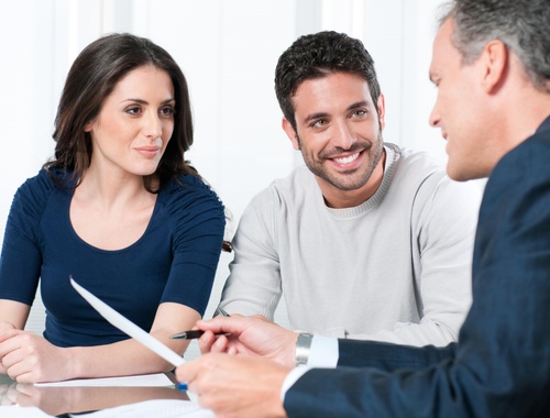 Office - Financial consultant reviews investments with a couple