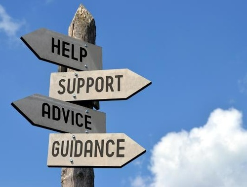 wooden posts with signs pointing to help, support, advice and guidance