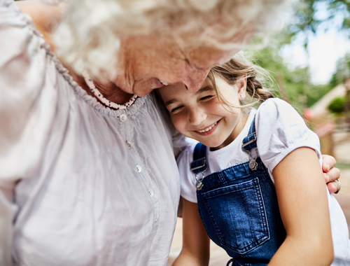 grandmother and granddaughter smiling
