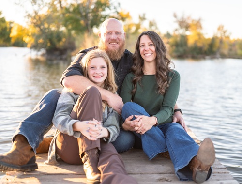Jacklyn Lundquist with her family by the lake