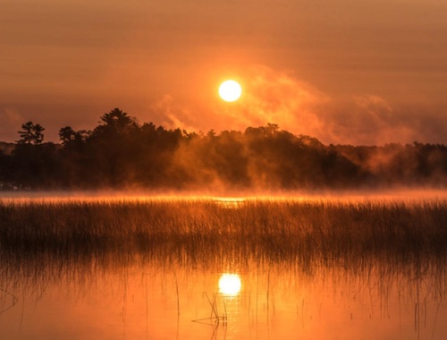 Photo of a warm sunset over a body of water