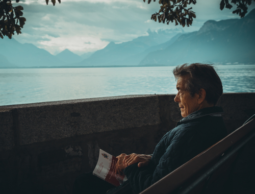 Person-reading-book-by-lake