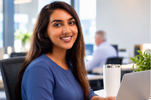Employee working at a laptop in a modern workplace